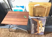 Group shot of slat table, stacked TV trays on stand, boxed bed tray
