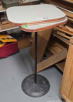Full view of pedestal bistro table with stacked spare tops