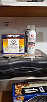 Stove case, Hotery burner box, Ronson fuel can on shelf