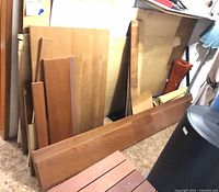 Stack of veneer sheets and boards leaning against wall
