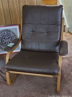 Front view of brown leather armchair with light bentwood frame