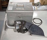 Premier vacuum and metal case with dust bag visible