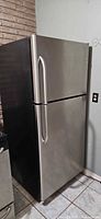 Front view of GE stainless steel top-freezer refrigerator