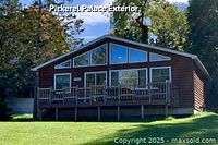 Exterior view of Pickerel Palace cedar cottage with deck and large windows