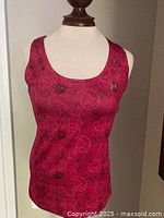 Front view of pink patterned Under Armour racerback tank top on mannequin