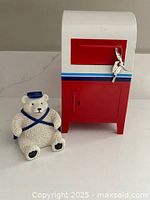 Front view of plastic mailbox with key and polar bear dispenser