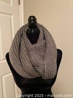 Scarf looped on mannequin showing chunky knit design