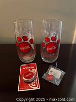 Full lot showing two paw print glasses, sealed Lip Smacker lip balm and lapel pin
