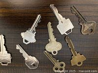 All eight keys laid out on dark wood surface