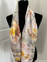 Yellow and grey tie-dye silk scarf draped on mannequin