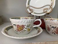 teacup on saucer showing floral pattern and rim detail