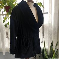 Front view of black wool-blend jacket on mannequin