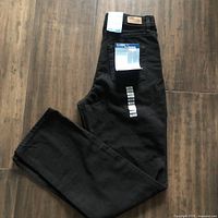 Full length view of black jeans showing tags attached