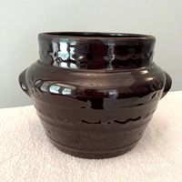 Front view of brown stoneware bean pot showing Daisy Dot pattern and handles