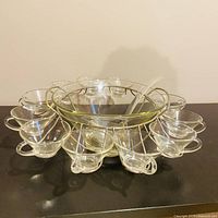 Full punch bowl set with cups hung on metal rack
