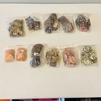 Overview of ten bags of assorted medallions and hearts on table