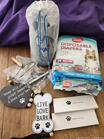 All items grouped: compressed stairs, diapers, grooming tools, Airtag boxes, wooden signs