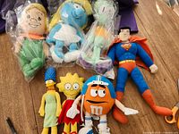 Group shot of all seven plush characters on table