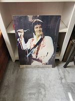 Full-colour photographic poster of Elvis Presley standing with guitar