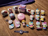 Group shot of all Hello Kitty Happy Meal toys and accessories on table