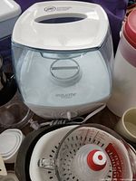 Humidifier, coffee decanter, colander, measuring cup, water dispenser visible