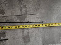 Upper sections of rods with guides and tape measure for scale