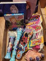 Boxed lot showing microphone, wand, balloon pack, puzzles, LOL cutout