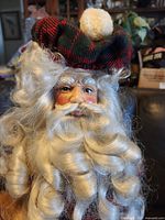 Close-up of Santa head with plaid tam and curly beard