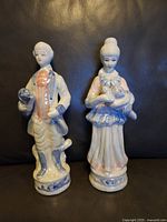 Front view of individual man and woman figurines