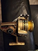 Left side view of Daiwa Mini-Mite reel showing branding and drag dial