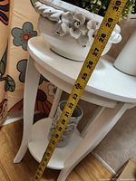 tape measure against table and planter showing height