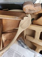Box of assorted wooden items including spoon, heart plaque, letters and stand parts