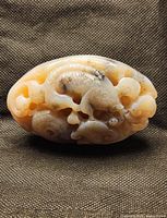 front view showing detailed fish and shell carving