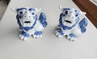 Two ceramic foo dog figurines front view