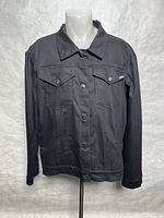 Front view of black Metal brand jacket on mannequin