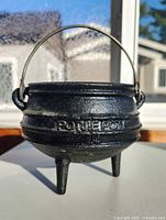 Cauldron front with POTJIEPOT embossing visible