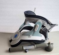 Side view of HelioMD Neck Revive stretcher with attached foam padding and separate hand pump