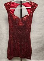 Front view of red sequined Guess dress on hanger