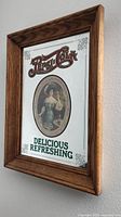 Front angled view of framed mirrored Pepsi-Cola sign