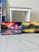 Both metal prints leaned against wall showing size and imagery