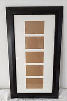 Full view of black collage frame showing five mat openings