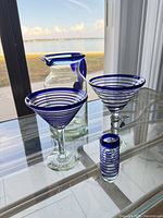 All four glass pieces grouped on glass table