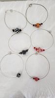 All six choker necklaces laid out showing overall assortment and bead designs