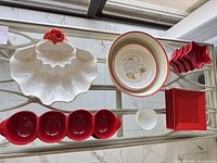 Top view of entire lot showing shell server, La Primula bowl, red condiment server, star bowls, white bowl, red dinner plates