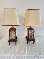 Front view of both porcelain table lamps on wood bases with shades