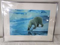 Full view of framed polar bear print in silver frame with mat