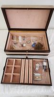 Overall view of open wooden storage box with accessories in top compartment and drawer