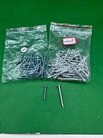 Two sample bags showing screw types plus two loose screws for scale