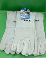 Three pairs grey welding gloves laid out