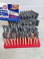 Front view of 48 foam brushes in red display base